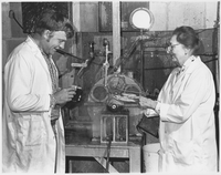 Alton F Brown left with Renata Martan  at small stone grinder examining pulp made on grinder